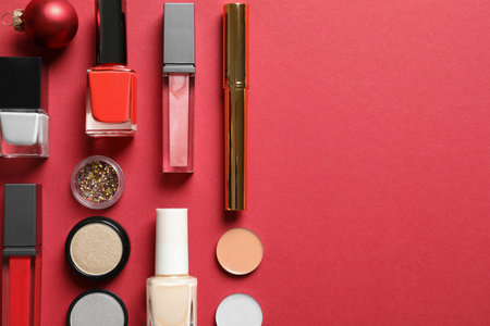 Flat lay composition with makeup products and Christmas decor on color background. Space for textの写真素材