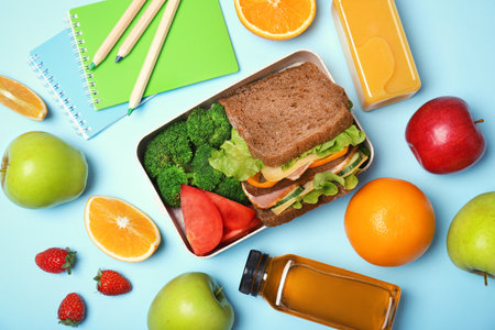Flat lay composition with healthy food for school child on color backgroundの写真素材