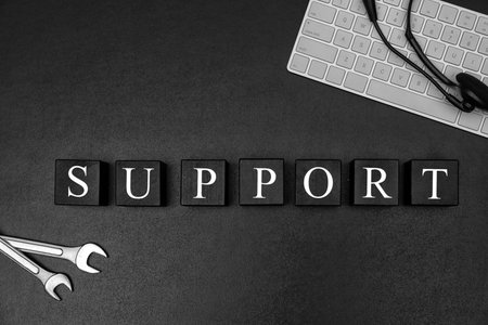 Cubes with word "SUPPORT" on dark background, flat lay composition. technical serviceの写真素材