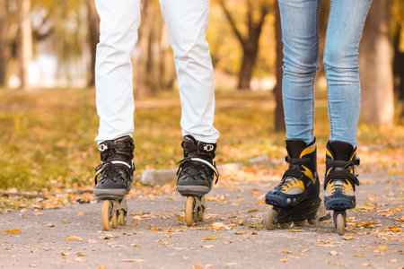 Couple roller skating in autumn park. Active leisureの写真素材