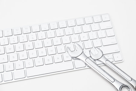 Wrenches and computer keyboard on light background. Concept of technical supportの写真素材