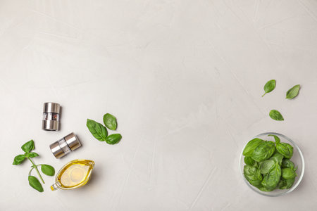 Flat lay composition with fresh basil leaves on light background. Space for textの写真素材