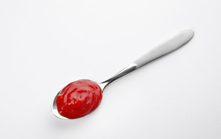 Tasty homemade tomato sauce in spoon on white background, top viewの写真素材