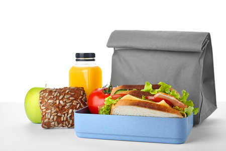 Lunch box with healthy food for schoolchild on white backgroundの写真素材