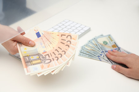 Woman exchanging money at cash department window, closeupの写真素材