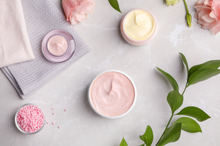 Flat lay composition with hand cream jars on light backgroundの写真素材