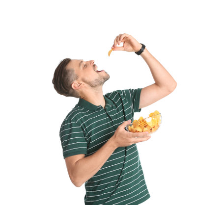 Man eating potato chips on white backgroundの写真素材