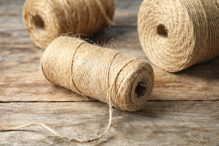 Natural hemp rope spools on wooden tableの写真素材