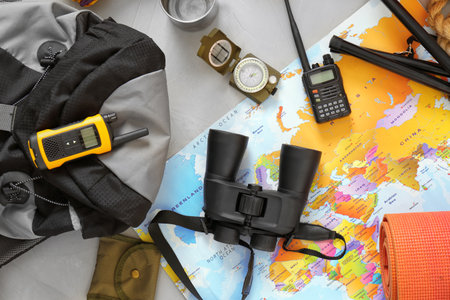Flat lay composition with map and camping equipment on gray backgroundの写真素材