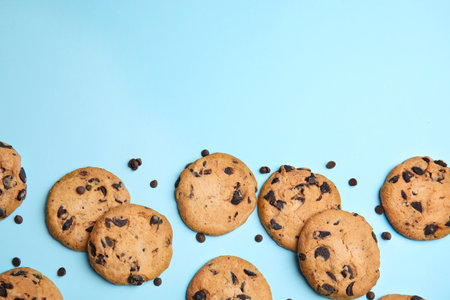 Delicious chocolate chip cookies on color background, flat lay. Space for textの写真素材