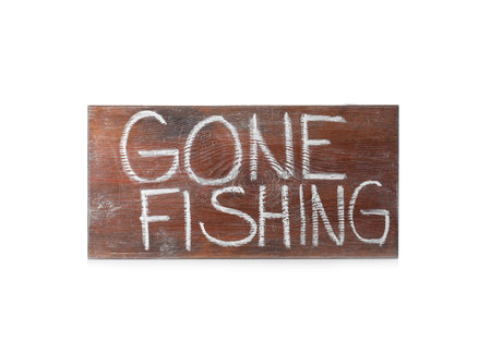 Wooden plank with words "GONE FISHING" on white backgroundの写真素材