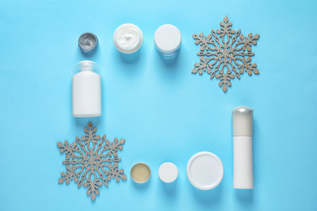 Set of cosmetic products on blue background, flat lay with space for text. winter careの写真素材