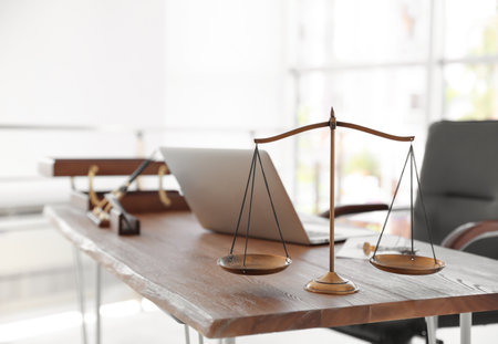Scales of justice on desk in notary's officeの写真素材