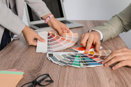 Team of designers working with palette colors at office table, closeup
