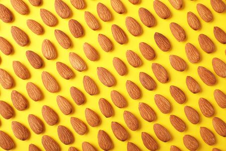 Composition with organic almond nuts on color background, top viewの写真素材