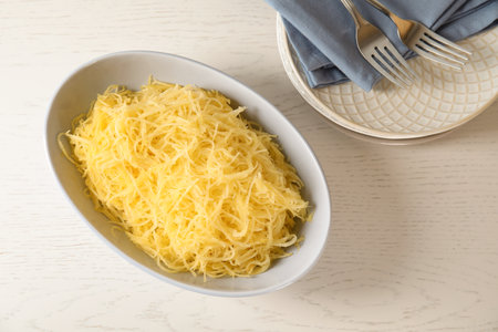 Cooked spaghetti squash in bowl on table, top viewの写真素材