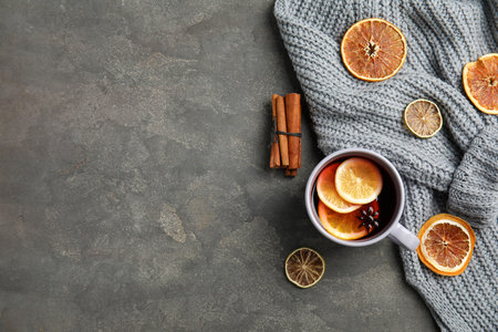 Flat lay composition with cup of hot winter drink and space for text on gray background. Cozy seasonの写真素材