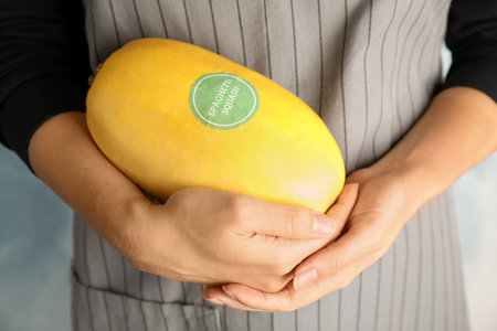 Woman holding spaghetti squash against color background, closeupの写真素材