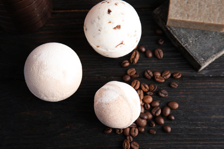 Flat lay composition with bath bombs, soap bars and coffee beans on wooden backgroundの写真素材