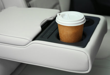 Takeaway paper coffee cup in holder inside carの写真素材