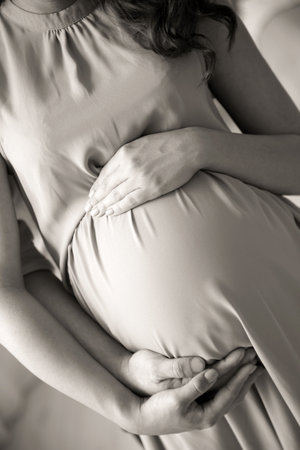 Pregnant woman with her husband, closeup. black and white effectの写真素材
