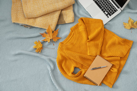 Flat lay composition with cozy knitted sweater on blanket. Space for textの写真素材