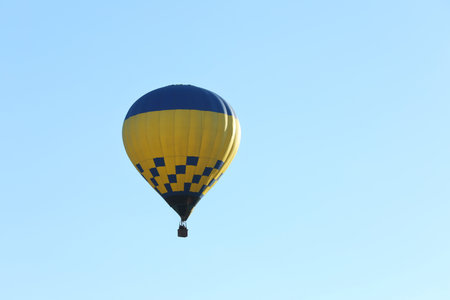 Colorful hot air balloon flying in blue sky. Space for textの写真素材