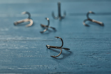 Fishing hooks on wooden table. Angling equipmentの写真素材