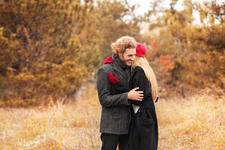 Young romantic couple in park on autumn dayの写真素材