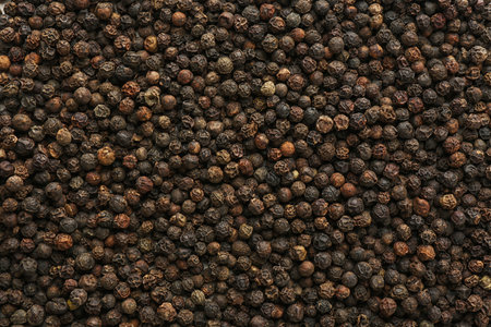 Black peppercorns as background. natural spice