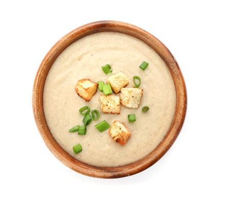 Bowl of fresh homemade mushroom soup on white background, top viewの写真素材