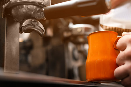 Male barista making espresso using professional coffee machine, closeupの写真素材