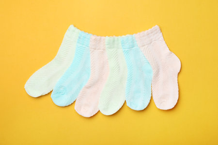 Cute child socks on color background, flat lay