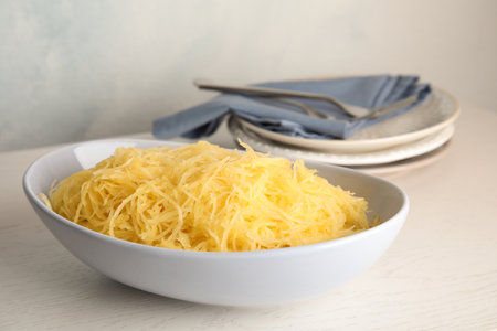 Cooked spaghetti squash in bowl on tableの写真素材