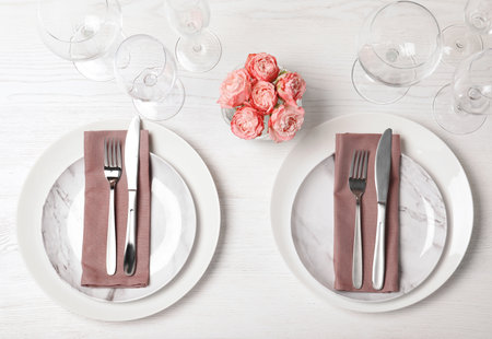 Festive table setting with plates, cutlery and napkins on wooden background, flat layの写真素材