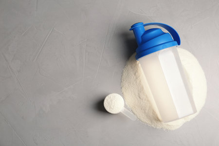 Bottle, protein powder and space for text on gray background, top view. preparation shakeの写真素材