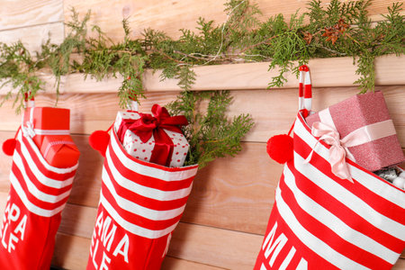 Christmas stockings hanging on wooden wall. Festive interior
