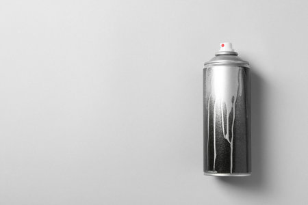 Used can of spray paint on color background, top view. Space for textの写真素材