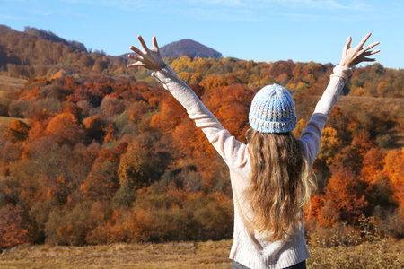 Female traveler feeling free in peaceful mountainsの写真素材