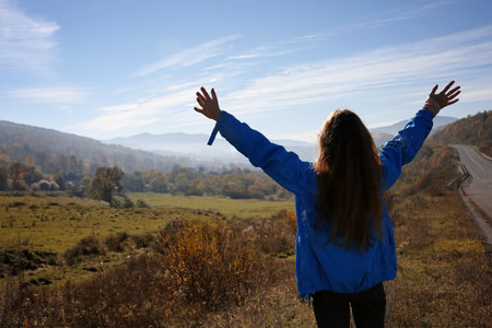 Female traveler feeling free in peaceful mountains