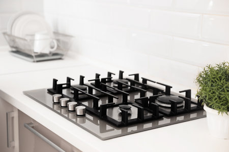 Modern built-in gas cooktop in light kitchenの写真素材
