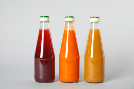 Bottles with different drinks on color backgroundの写真素材