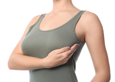 Woman checking her breast on white background, closeupの写真素材