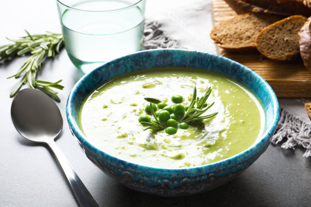 Fresh vegetable detox soup made of green peas in dish served on tableの写真素材
