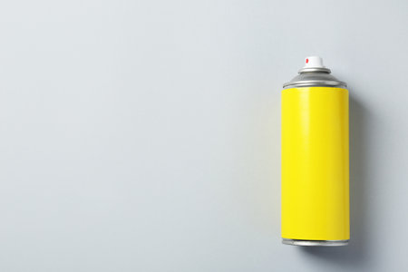 Can of spray paint on color background, top view. Space for textの写真素材