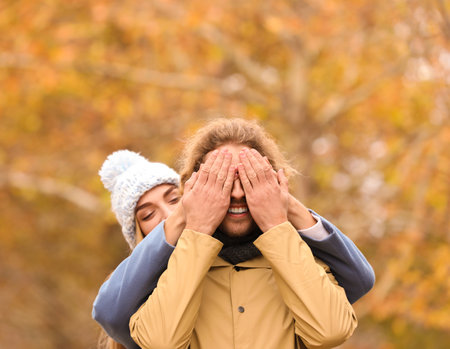 Young romantic couple having fun in park on autumn dayの写真素材