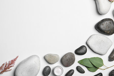 Flat lay composition with spa stones and space for text on white backgroundの写真素材