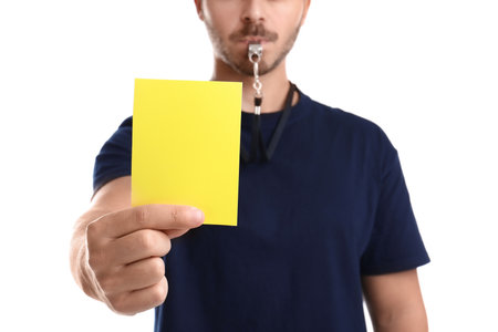 Football referee holding yellow card on white background, closeupの写真素材