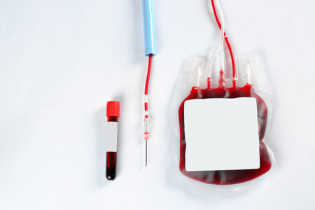 Blood pack for transfusion and test tube on white background, top view. Donation dayの写真素材