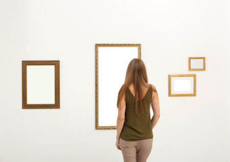 Young woman viewing exposition in modern art galleryの写真素材